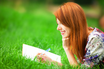 beautiful young woman with note at outdoor