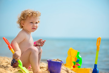 Cute little girl playing with sand
