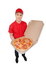 Delivering pizza. Top view of cheerful young deliveryman holding