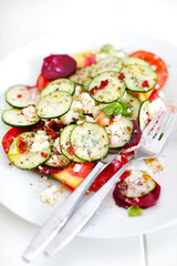 Cucumber salad with tomatoes, cottage cheese and chili basil