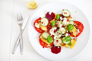 Summer salad of mango, tomato, beetroot, cucumber and feta