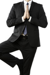 Businessman performs a yoga exercise