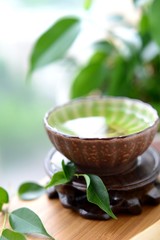 Healthy green tea cup with leaves