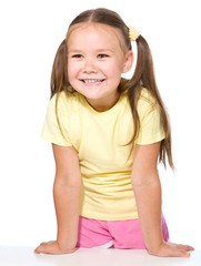 Portrait of happy little girl leaning on a table