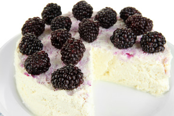 Cheesecake with fresh berries on white plate closeup