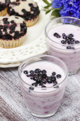 Blueberry smoothie on wooden rustic tray. Summer party