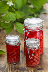 Glass jars of preserves on wooden table