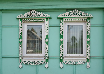 Two windows with carved platbands