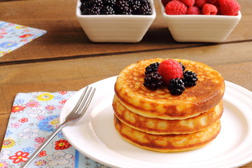 Pancakes with syrup and fruits of the forest