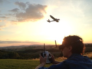 man flying remote airplane