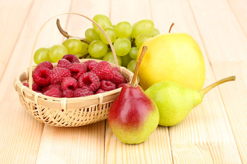 ripe sweet fruits and berries on wooden background