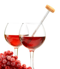 Glasses of wine with thermometer and grape, isolated on white