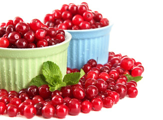 Ripe red cranberries in bowls, isolated on white.