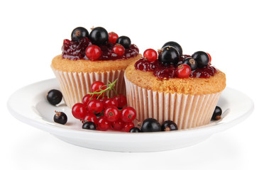 Tasty muffins with berries isolated on white