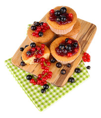 Tasty muffins with berries isolated on white