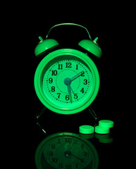 Old style alarm clock isolated on black