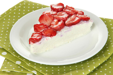 Cheesecake with fresh berries on white plate closeup