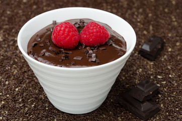 chocolate mousse with fresh raspberries in a white bowl