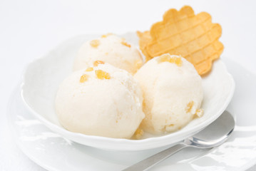 Close-up of ginger ice cream with melted milk and thin waffles