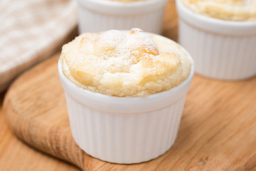 peach souffle in the portioned form on a wooden board, close-up