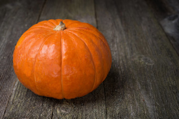 round orange pumpkin on the old wooden background