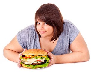 Woman holding big hamburger.