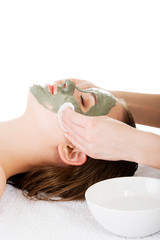 Obraz na płótnie Canvas Beauty treatment in spa salon. Woman with facial clay mask.