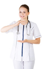 Medical doctor woman or nurse presenting and showing copy space