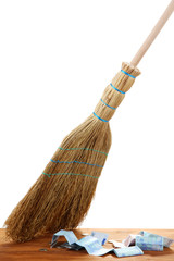 Broom sweep the euro on white background close-up