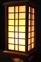 Japanese table lamp on black background