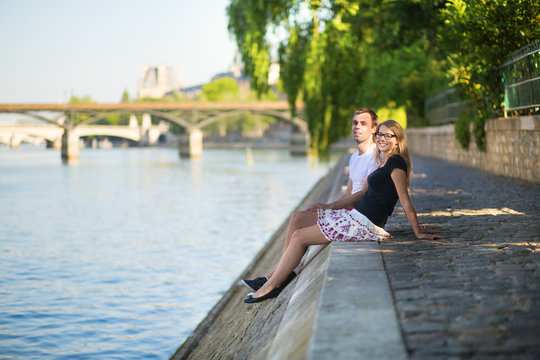 Couple relaxing on the bank of the Seine
