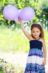 girl playing with balloons