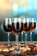 Glasses of liquors with almonds and coffee grains,