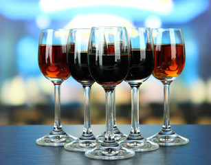 Glasses of liquors, on bright background