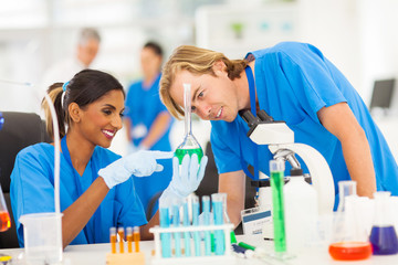 two scientists studying substances in laboratory