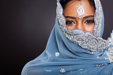 indian woman in sari with her face covered