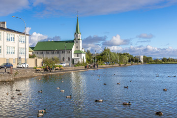 At Tjörnin with view on church Fríkirkja, Reykjavik, Iceland