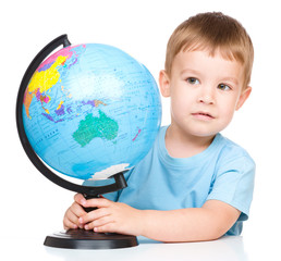 Happy little boy with a globe