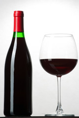 Wine bottle and a glass filled with wine isolated on white
