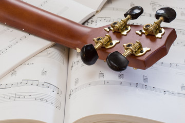 A ukulele sitting on music books