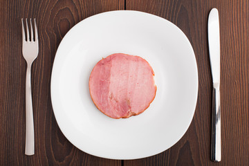 Slice of ham on white plate