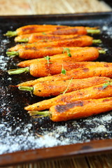 Baked whole carrots on a baking sheet