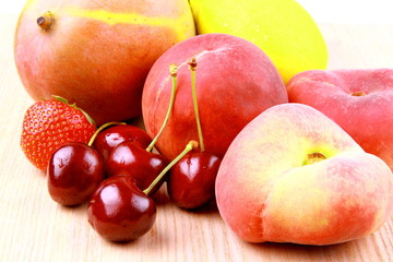 Cherries, platt peach, strawberries, lemon and mango, close up