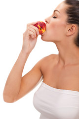 Beautiful young woman eating a peach © V&P Photo Studio