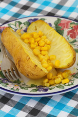 Jacket potato with cheese and sweetcorn, close up