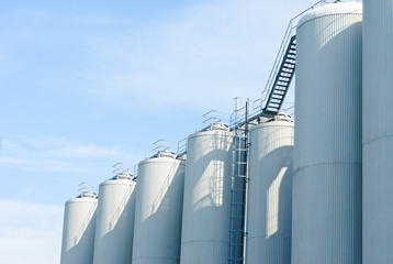 brewery tanks blue sky big containers beer production industry