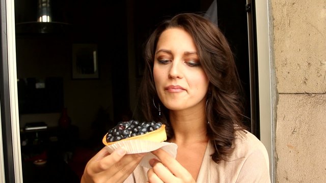 Young Woman Eating the blackberry Cake