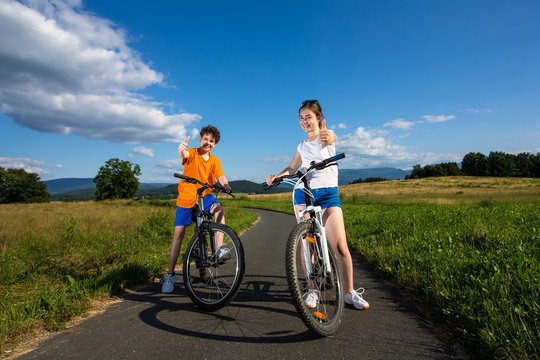 Healthy lifestyle - teenage girl and boy biking