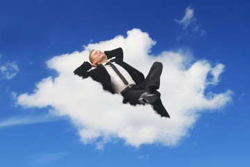 Businessman sleeping in a cloud