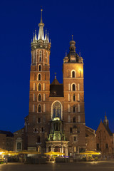 Fototapeta premium Poland, Krakow, Mariacki Church Facade Lit up at Dusk